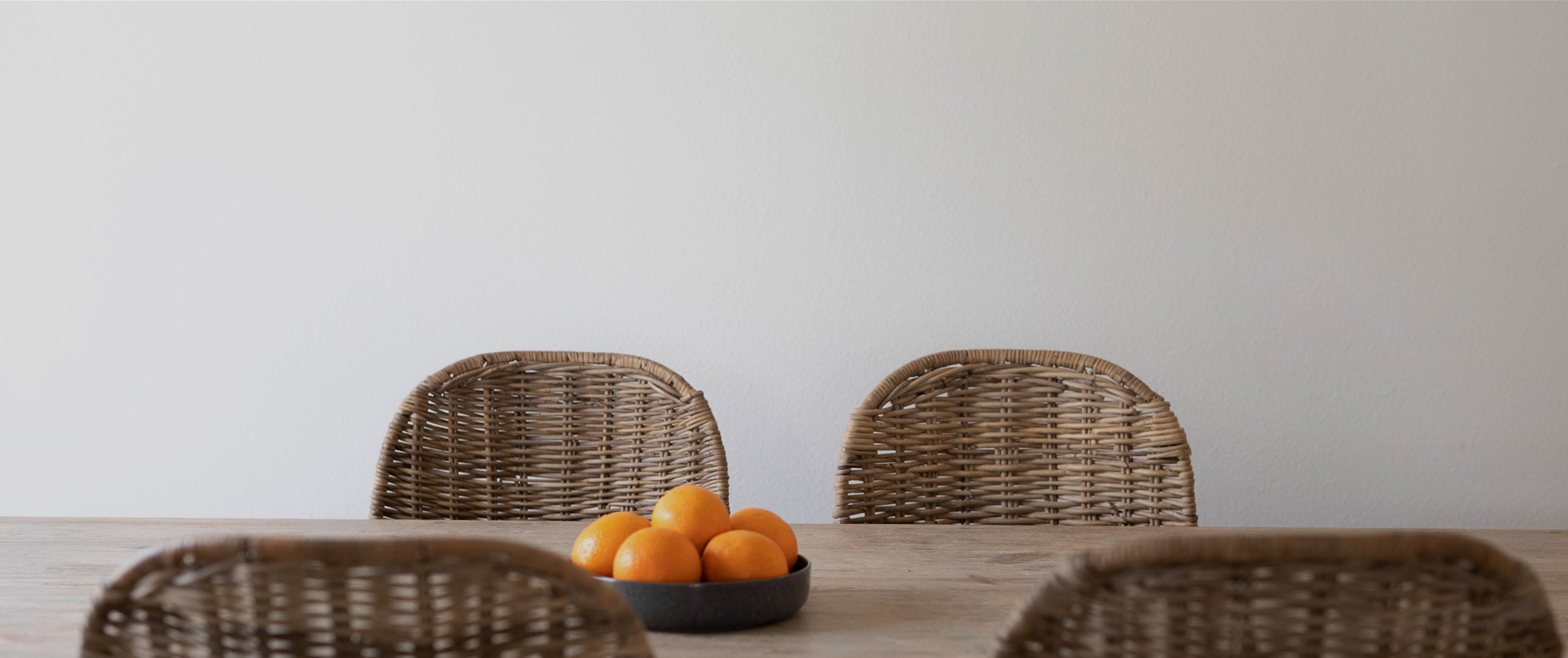 Rattan chairs around a dining table
