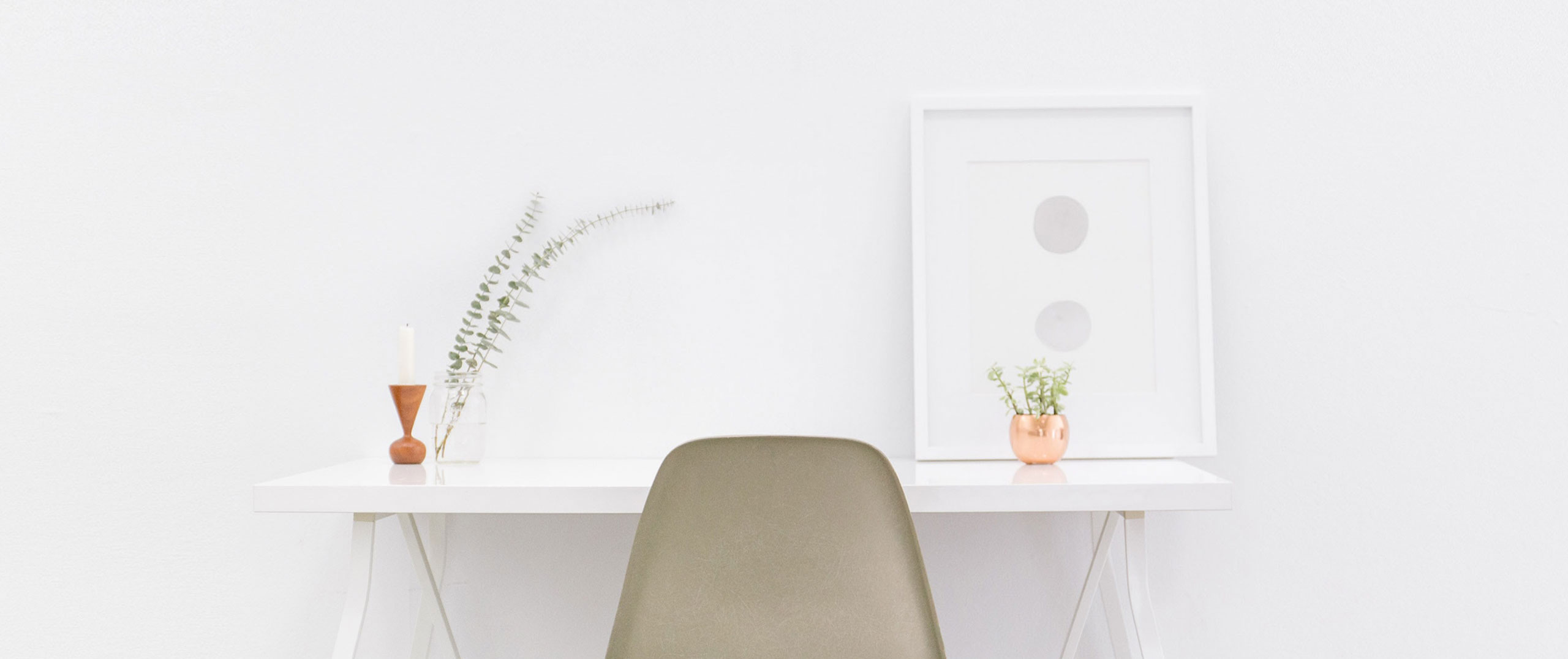 A clean white desktop with a modern beige chair