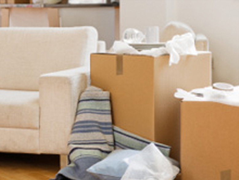 moving boxes stacked next to a couch