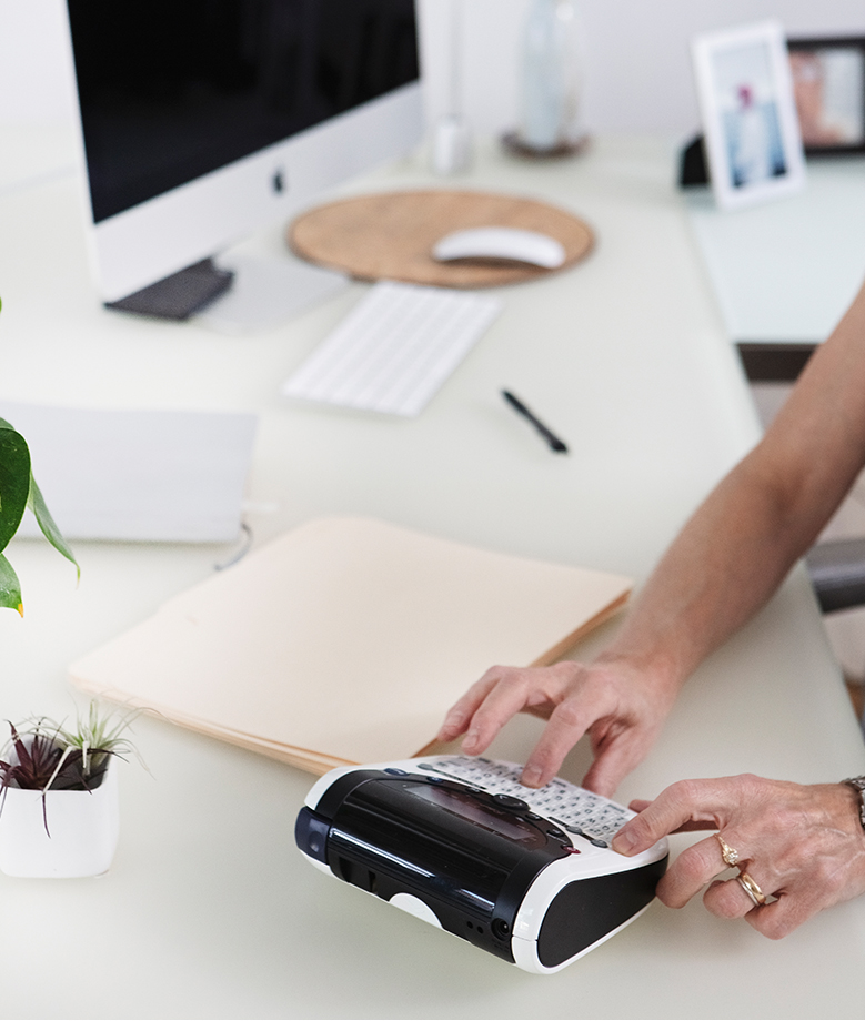 woman's hands working at a desk
