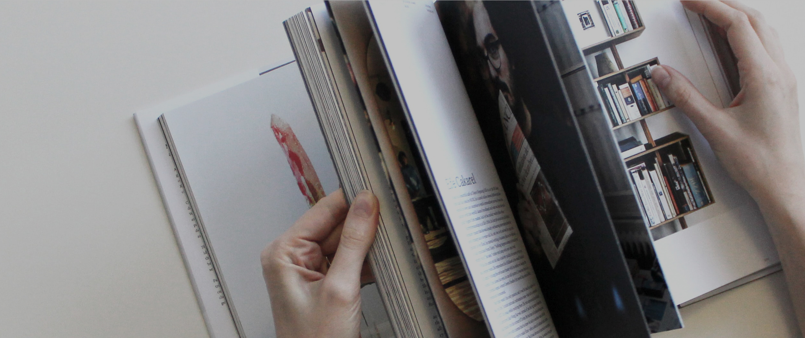 Hands leafing through a magazine