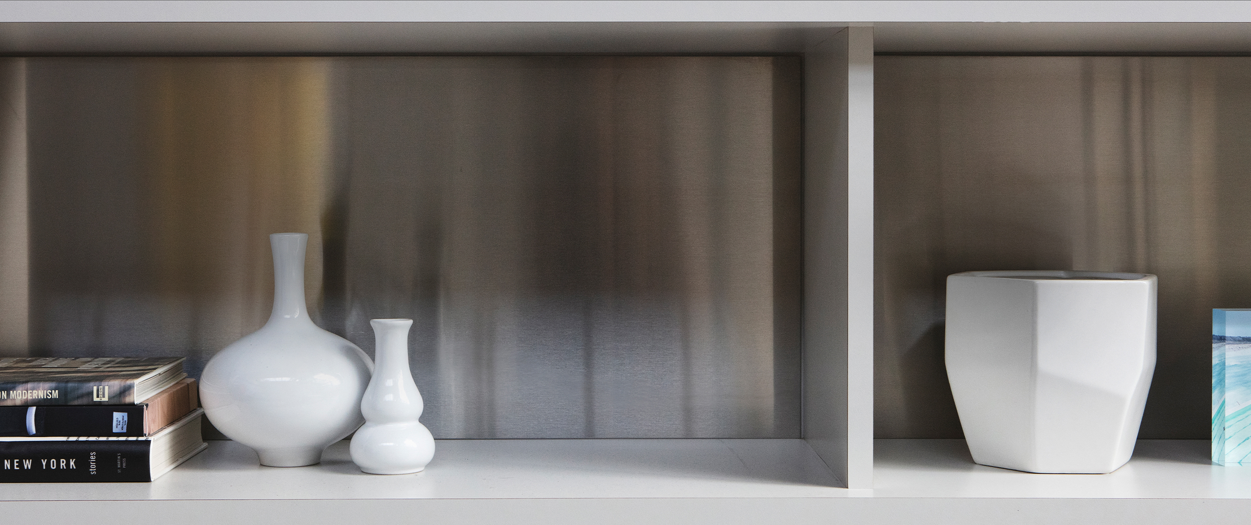 Close-up of the interior of shelf holding pottery